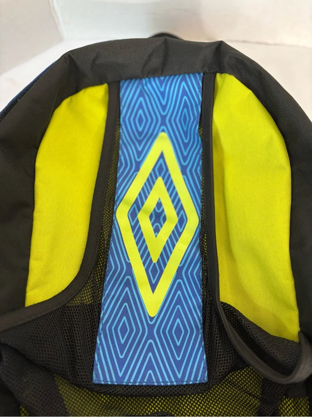 The Umbro soccer backpack features a distinctive blue diamond pattern